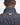 Close-up back view of a person wearing a Barbour Ogston Waxed Jacket in Navy, showing the collar and a gold-tone metal brand plaque on the upper back.