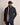 A man wearing a Bugatti All-Season Jacket, Navy, a tan scarf, a navy baseball cap, and navy trousers, standing against a solid beige studio background.