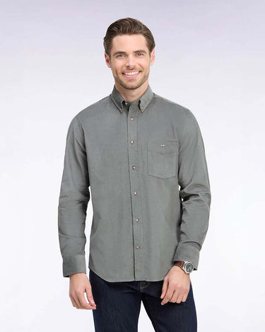 A man wearing a Eden Park Casual Shirt in Khaki with a chest pocket, paired with dark jeans, standing against a light gray studio background.
