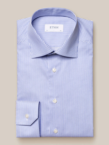 A striped, royal blue and white fine twill shirt by ETON, displayed flat on a surface.