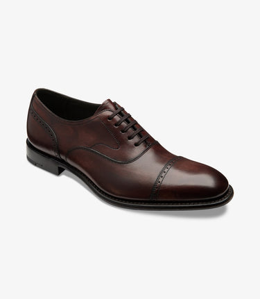 A single Loake Hughes Shoe, Burgundy with a lace-up closure and a cap-toe design on a white background.