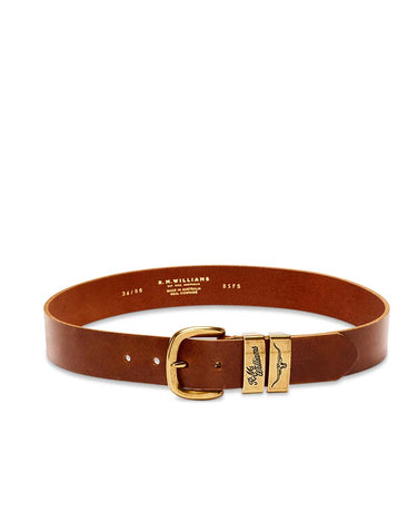 A bR.M. Williams Drover Belt, Caramel with a gold-tone buckle and a signature winged 'M. Williams' metal keeper, displayed on a clean white background.