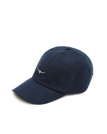 A R.M. Williams Longhorn Twill Cap, Blue Wash with a small silver metallic 'CF' logo on the side, photographed on a clean light gray studio background.