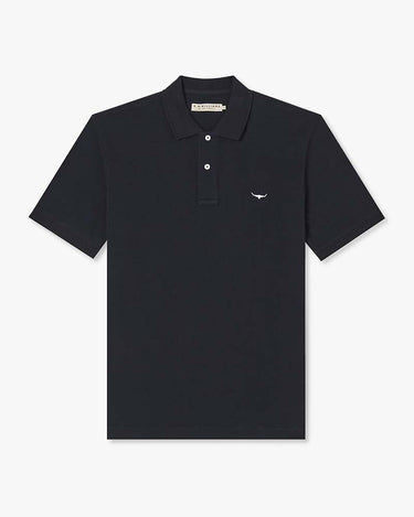 A R.M. Williams Rod Pique Polo, Navy with a three-button placket and a small embroidered eagle logo on the left chest, displayed flat against a light gray background.