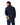 Man wearing a R.M. Williams Rydal Padded Gilet, Navy over a blue shirt on a white background