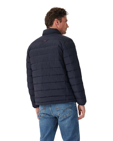 A man wearing a R.M. Williams Rydal Padded Jacket, Navy, shown from the back, paired with blue jeans against a plain white background.