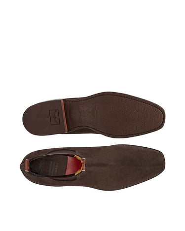 A pair of R.M. Williams Suede Craftsman Boot, Chocolate shown from the top, displaying the square toe, side elastic gusset, and the sole with a heel tab.