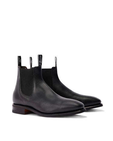 A pair of R. M. Williams Comfort Craftsman Boot Wide Fit, Black with elastic side gore panels, shown from a three-quarters angle on a clean white background.