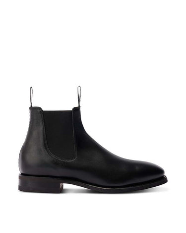 A single R. M. Williams Comfort Craftsman Boot Wide Fit, Black with a low block heel and elastic side gore, shown in profile against a plain white background.