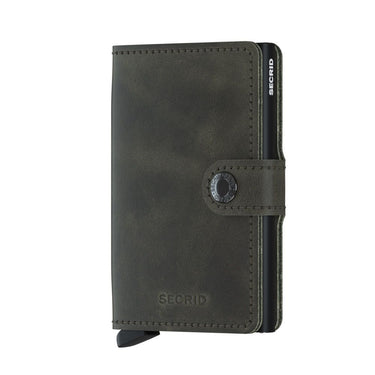 A vintage olive/black Secrid mini wallet with a snap closure.
