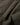 Close-up of dark olive green fabric with visible stitching and a textured, slightly ribbed material surface.