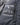 Close-up of a Strellson Padded Light Jacket, Dark Blue showing a zippered pocket with white printed text and icons including 'Recycled Padding', 'Duck Feathers', 'All Time Favourite', and 'Travel Light'.