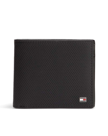 A Tommy Hilfiger Leather Coin Wallet, Black with a perforated leather texture, featuring a small Tommy Hilfiger flag logo on the bottom right corner, set against a plain white background.