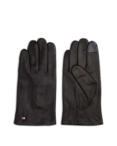 A pair of Tommy Hilfiger Napa Leather Gloves, Black, one showing the back of the hand and the other showing the palm side with a touch-screen-compatible black rubberized tip on the index finger, displayed on a clean white background.
