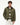 A man wearing an olive green Tommy Hilfiger Corduroy Collar Padded Ripstop Barn Jacket, layered over a striped sweater and white trousers, photographed against a plain white studio background.