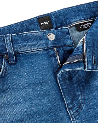 Close-up of BOSS Re.Maine Regular Fit Jeans, Mid Blue showing the waistband, button closure, zipper pocket, and interior labels including BOSS and REMA 95.