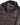 A close-up of a Barbour Ogston Waxed Jacket in Rustic Brown, featuring a corduroy collar, silver snap buttons, and a plaid lining visible at the open front.