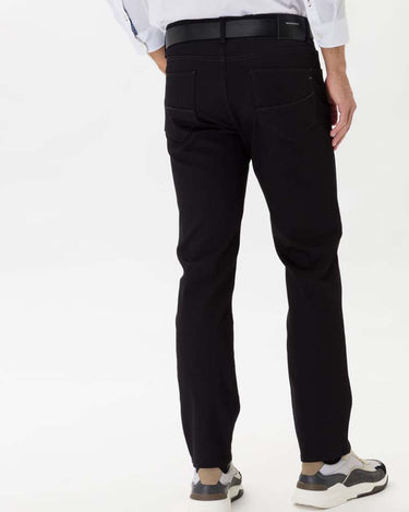 Person wearing Brax Cadiz Straight Fit Jeans, Black on a white background
