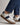 Carl Gross Urs Leather Trainer, Blue Grey with white laces worn with blue pants on a neutral background