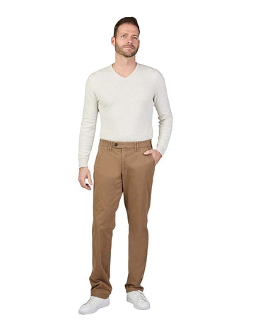 A man modeling a light beige v-neck knit sweater and Club of Comfort Denver Chino, Beige with white sneakers, standing against a solid white background.