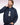 A man wearing a Eden Park Nylon Blouson Jacket, Navy over a navy and white graphic sweatshirt, posing against a light pink studio background.