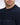 Close-up of a man wearing a Eden Park Textured Stripe Crew Neck, Navy sweater with a small white embroidered logo on the chest pocket.
