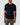 Man wearing a Eton Filo di Scozia T-Shirt, Navyand beige pants against a light gray background