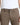 A close-up of a person wearing MAC Driver Pants in Chocolate Brown with a white t-shirt, showing the front waistband, belt loops, button, and front pocket.