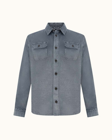 A Paul & Shark Corduroy Overshirt, Ombre Blue in a washed slate blue denim-like fabric, featuring two buttoned chest flap pockets and a pointed collar, shown against a plain off-white background.