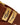 Close-up of a R.M. Williams Drover Belt, Caramel with a gold-toned rectangular buckle engraved with 'R.M.