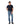A man modeling a R.M. Williams Parson T-Shirt, Navy and blue jeans against a solid white background.