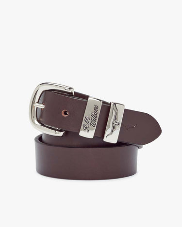 A R.M. Williams Slim Drover Belt, Chestnut with a polished silver-tone buckle and matching silver-tone metal keeper, featuring the Louis Vuitton script logo engraved on the buckle plate.