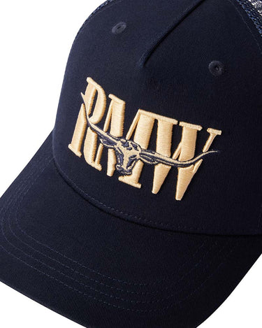 A close-up of a R.M. Williams Steerhead Trucker Cap, Navyfeaturing a large gold embroidered 'RMW' logo with a longhorn steer graphic in the center.