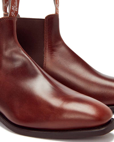 A close-up of a pair of R. M. Williams Comfort Craftsman Boot Wide Fit, Brown with elastic side panels and pull tabs, photographed on a clean white background.