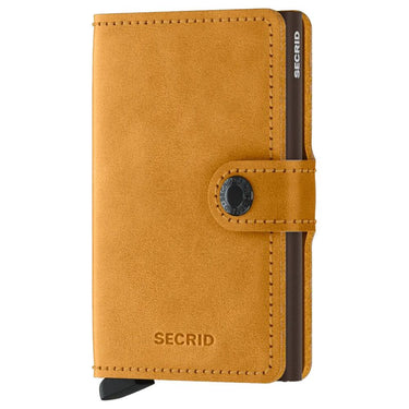 A yellow Secrid miniwallet with a snap closure and branding on the front.