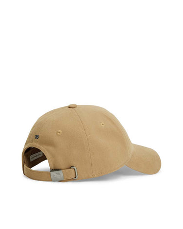 A Tommy Hilfiger 1985 Brushed Baseball Cap, Camel shown from a rear three-quarter angle, featuring an adjustable hook-and-loop strap with a silver metal buckle and a small embroidered logo on the side, set against a plain white background.