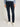 Person wearing Tommy Hilfiger Denton Jeans, Blue Black and white sneakers on a plain background