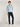 Man wearing a light blue Tommy Hilfiger sweatshirt and Tommy Hilfiger Denton Jeans, Blue Black on a white background