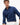 A man wearing a navy blue Tommy Hilfiger Dobby Cotton Shirt, Navy with white pants, photographed against a clean white studio background.