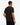 A man viewed from the back wearing a Tommy Hilfiger Flag Cotton T-Shirt, Brownand dark navy pants, set against a plain white studio background.