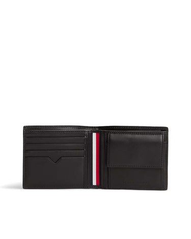 A Tommy Hilfiger Leather Coin Wallet, Black shown open, featuring multiple card slots, a central vertical stripe with red, white, and blue, and a slip pocket on the right side.