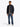 Man wearing a Tommy Hilfiger Packable Quilted Jacket, Navy, gray shirt, blue pants, and white shoes on a white background